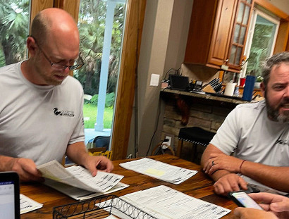 Steve DeMoor at his desk reviewing Dr. Critter's transparent pricing guarantee